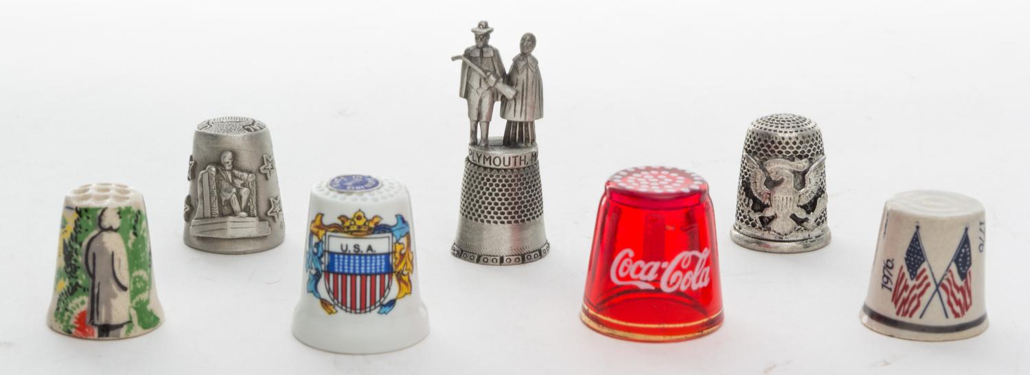 A Collection of Seven Americana Themed Thimbles Height of tallest 1 7/8 inches.
