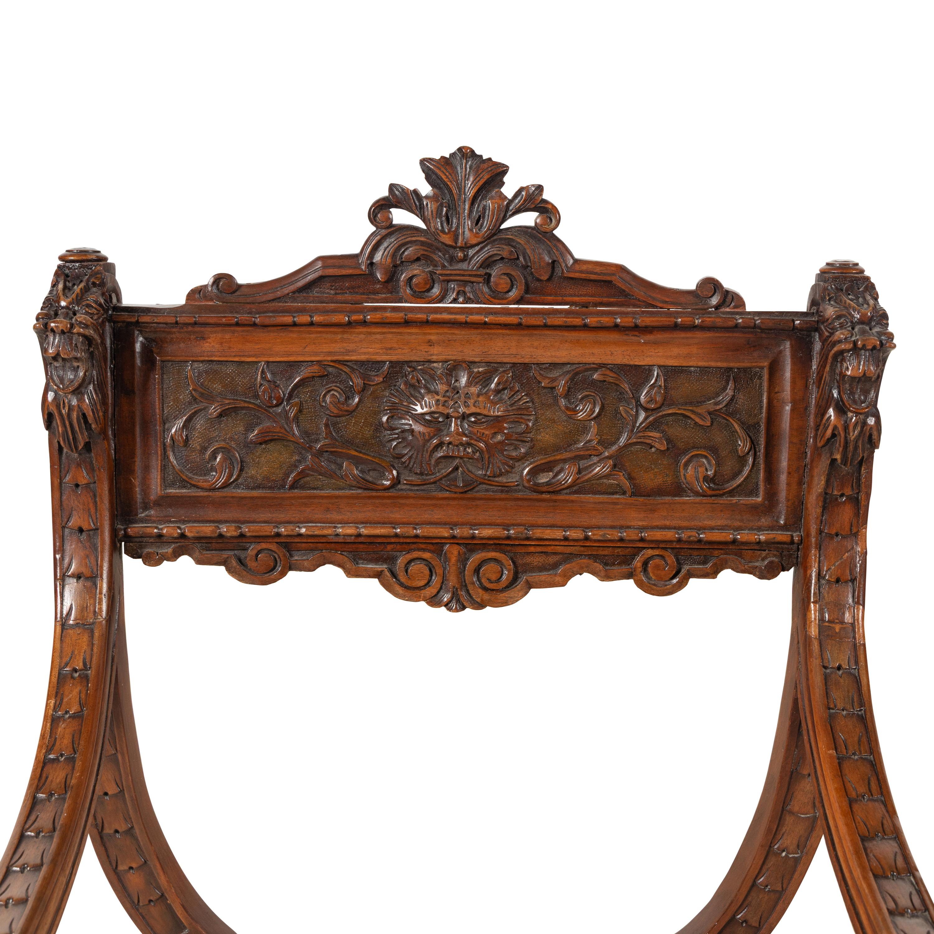 A Pair of Italian Carved Walnut Savonarola Chairs