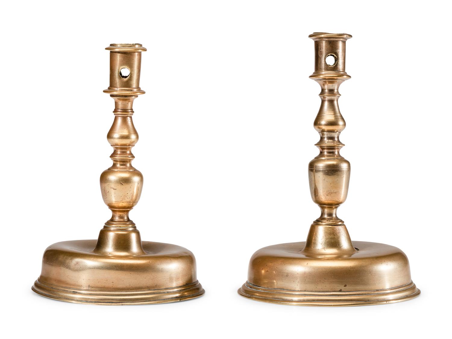 A Near Pair of Dutch William and Mary Brass Bell-Bottom Candlesticks