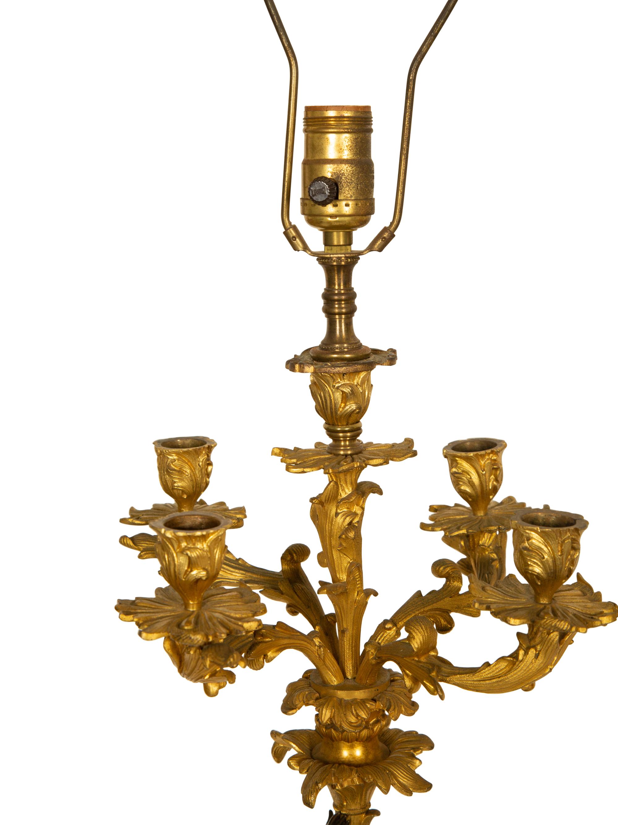 A Pair of Patinated and Gilt Bronze Figural Five-Light Candelabra Mounted as Lamps
