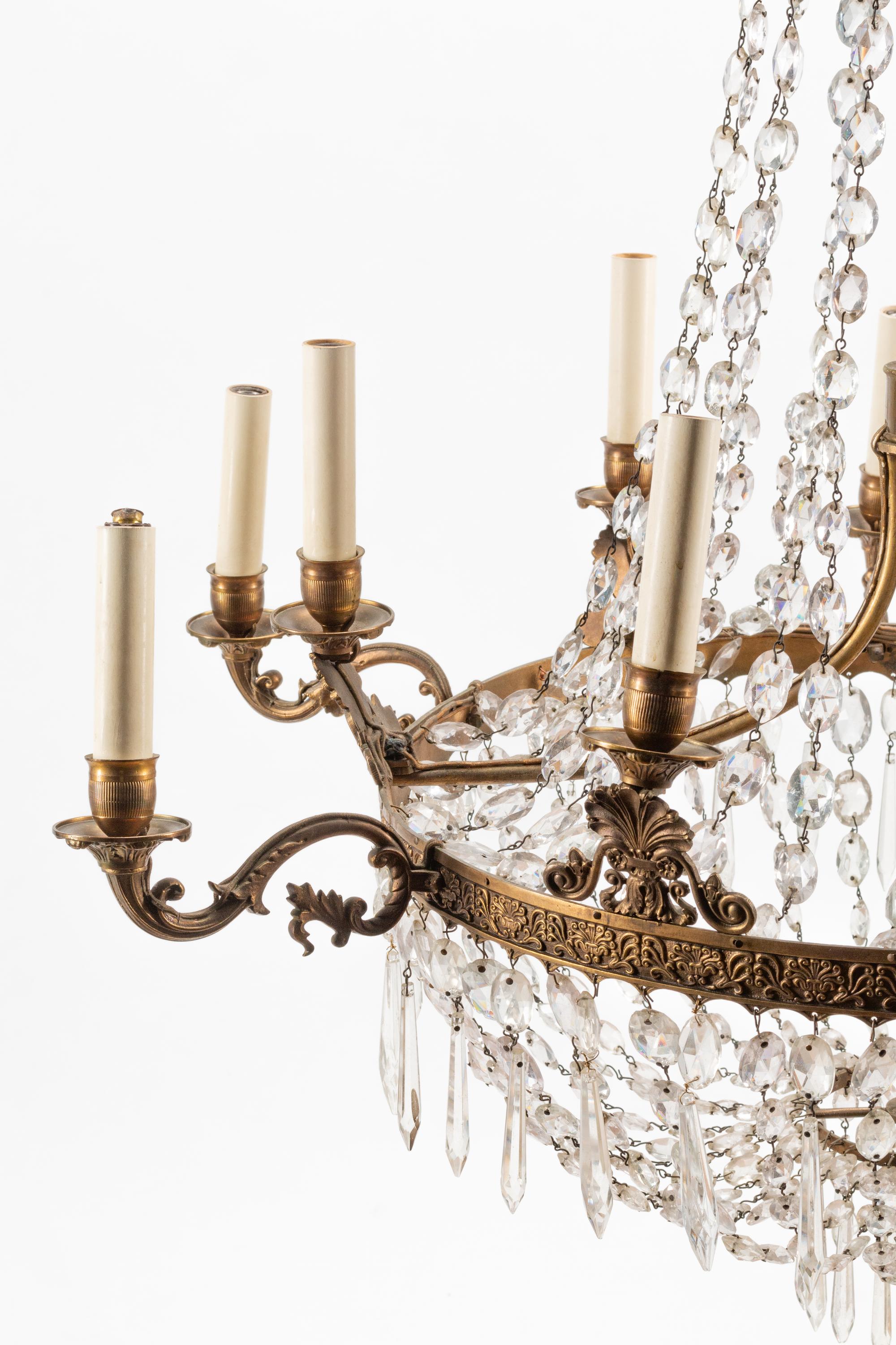 An Empire Style Bronze and Glass Twelve-Light Chandelier