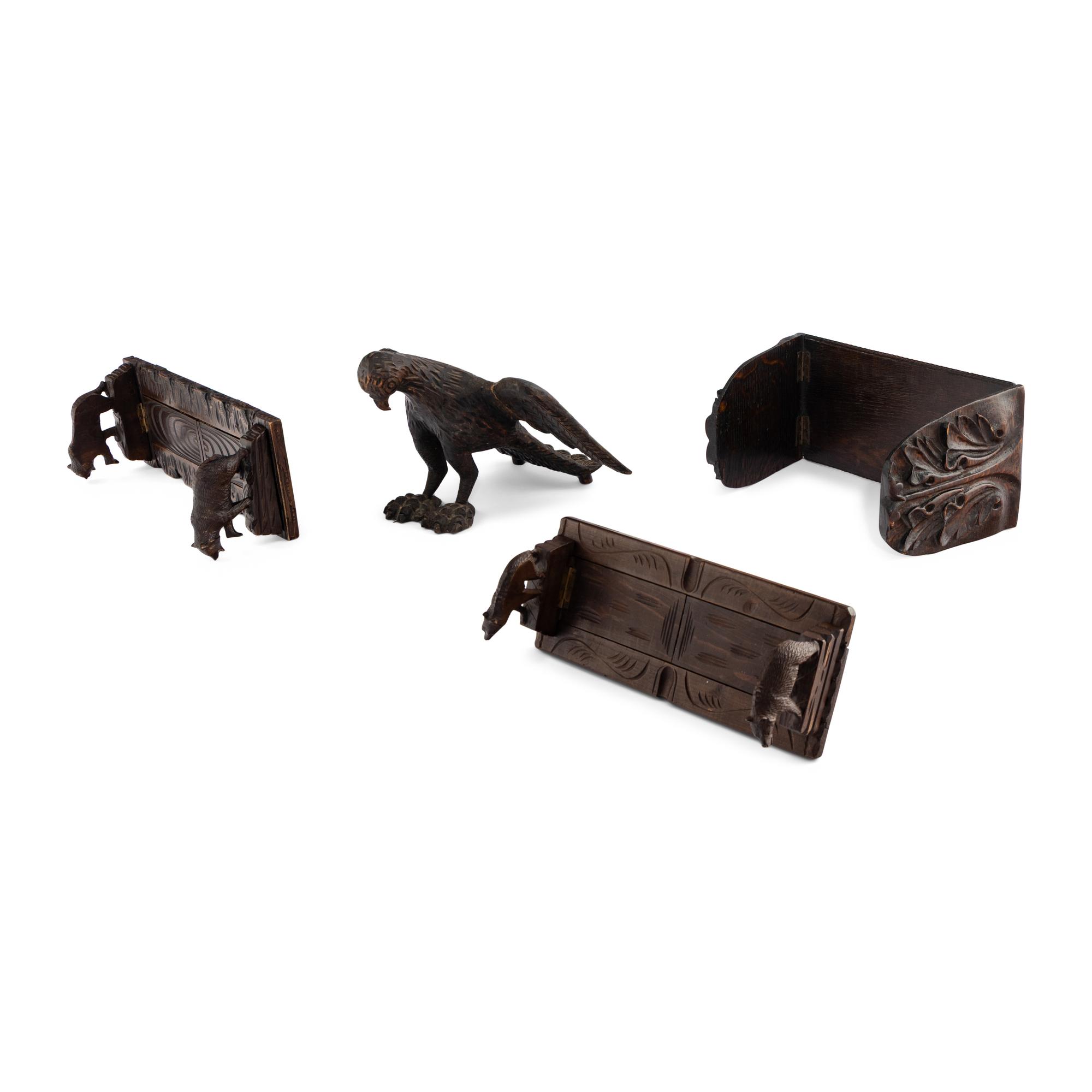A Group of Four Black Forest Carved Book Racks and Stands