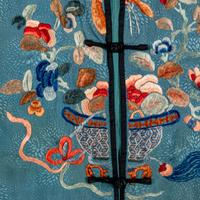 A Chinese Celeste Blue Ground Embroidered Silk Lady's Jacket 清晚期 藍地牡丹花籃紋褂