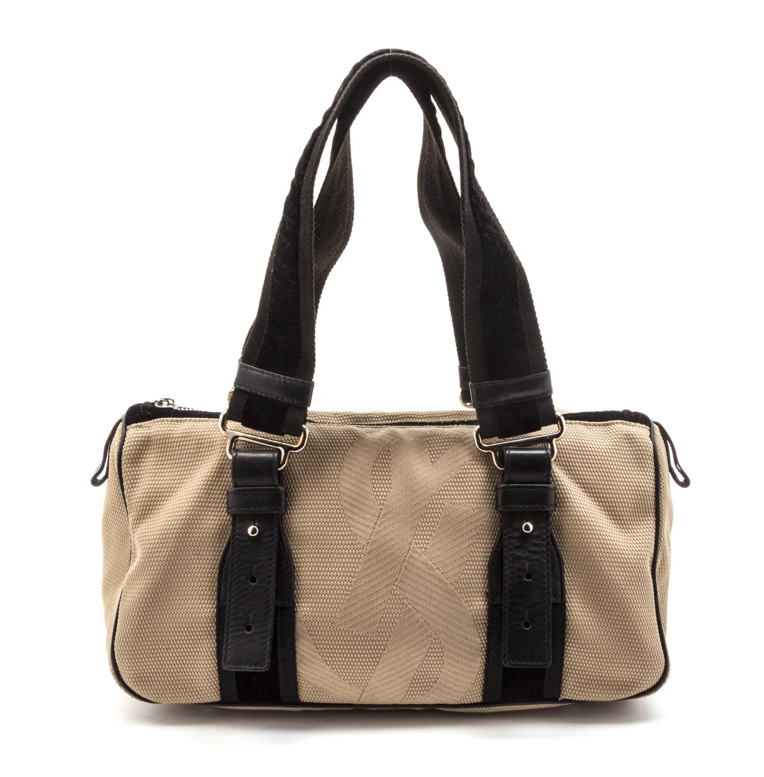 An Yves Saint Laurent Tan Canvas Bag, 11 x 7 1/2 x 2 inches.