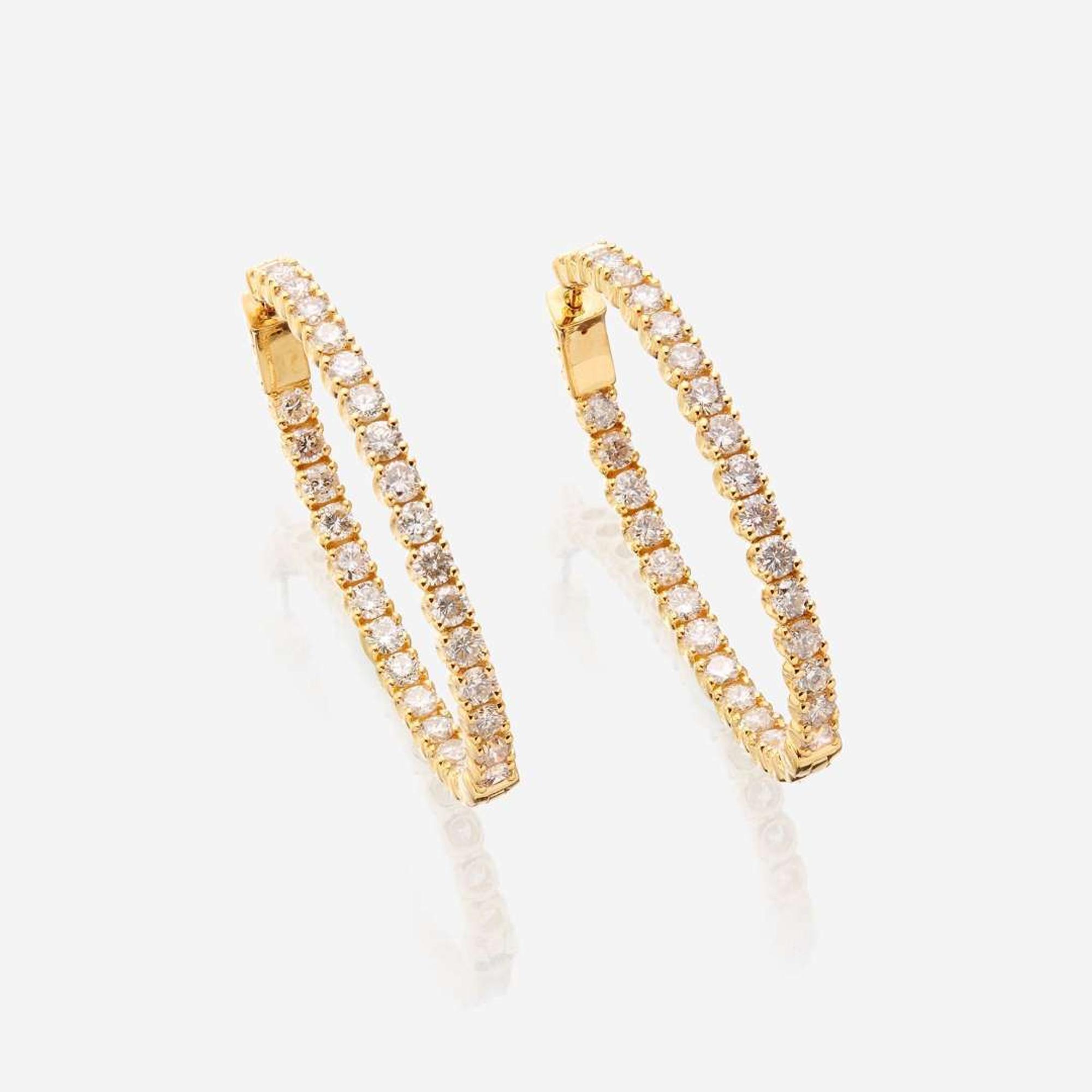 A pair of diamond and fourteen karat gold earrings