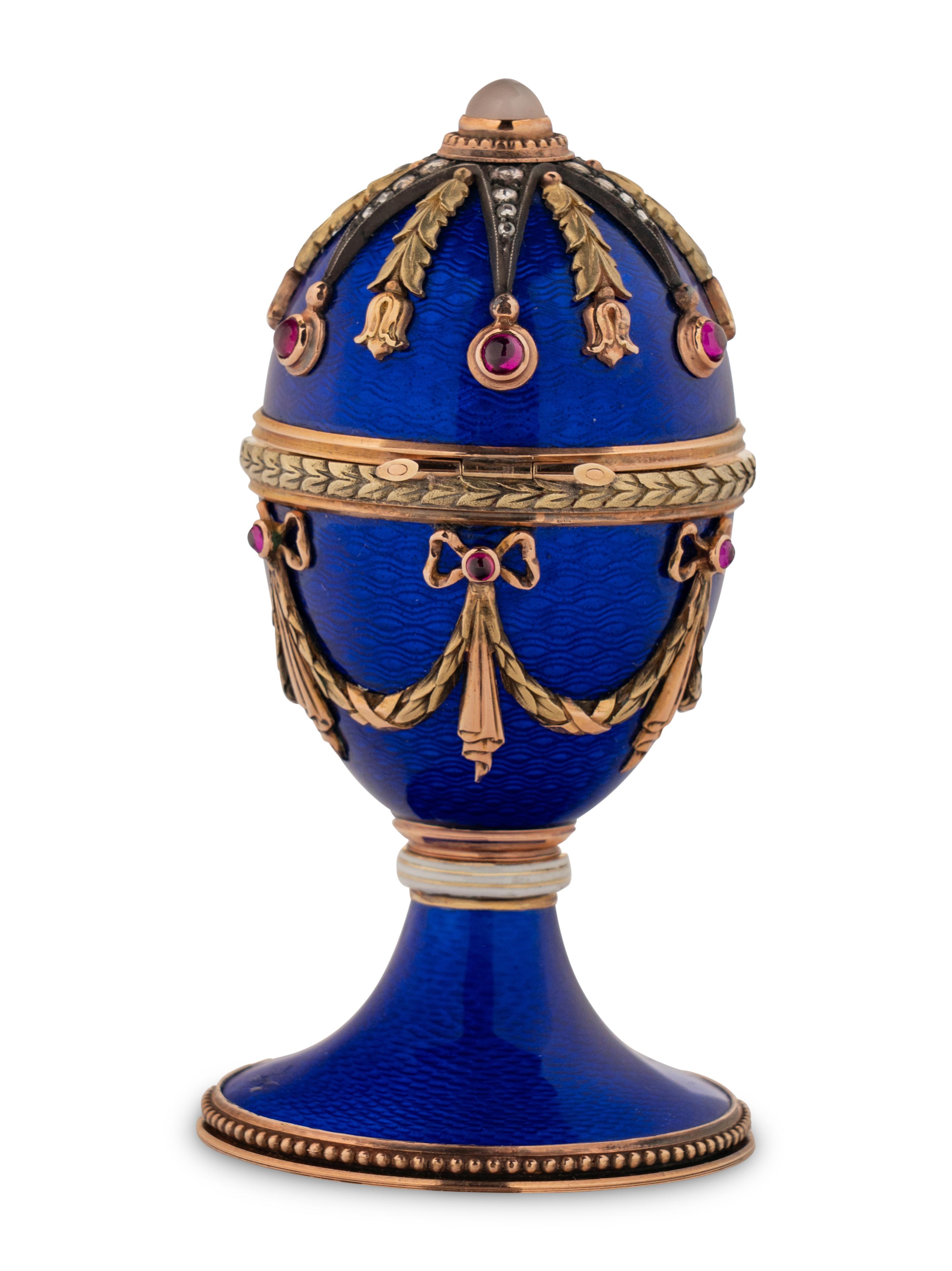A 14 Karat Vari-Color Gold, Guilloché Enamel, Diamond, and Cabochon Jewel-Mounted Egg-Form Perfume and a Related Guilloché Enamel, 14 Karat Vari-Color Gold, Diamond, and Cabochon-Mounted Surprise Egg