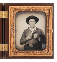 [CIVIL WAR]. Sixth plate ruby ambrotype of a young man armed with a Prescott Revolver and a clenched fist.