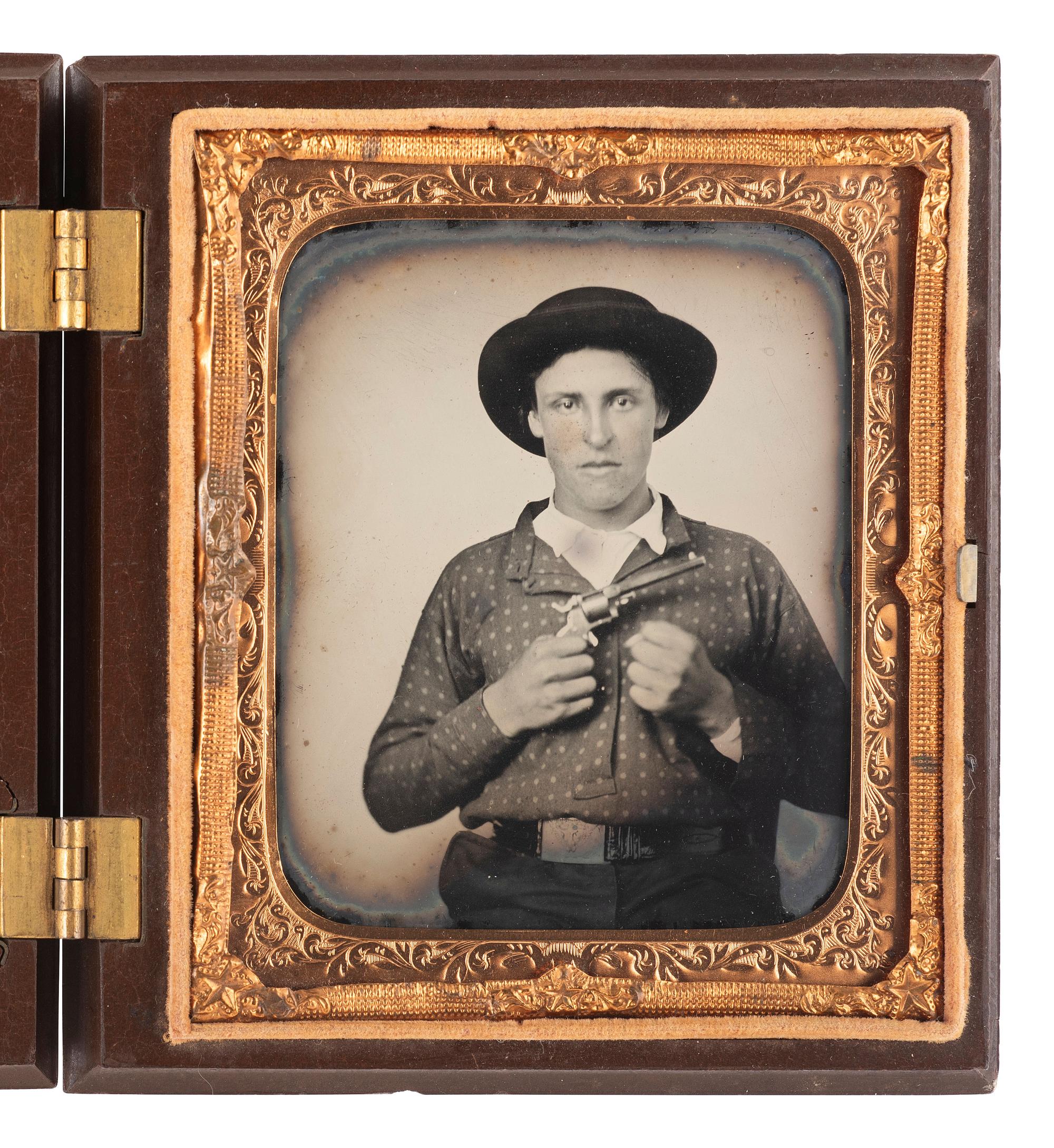 [CIVIL WAR]. Sixth plate ruby ambrotype of a young man armed with a Prescott Revolver and a clenched fist.