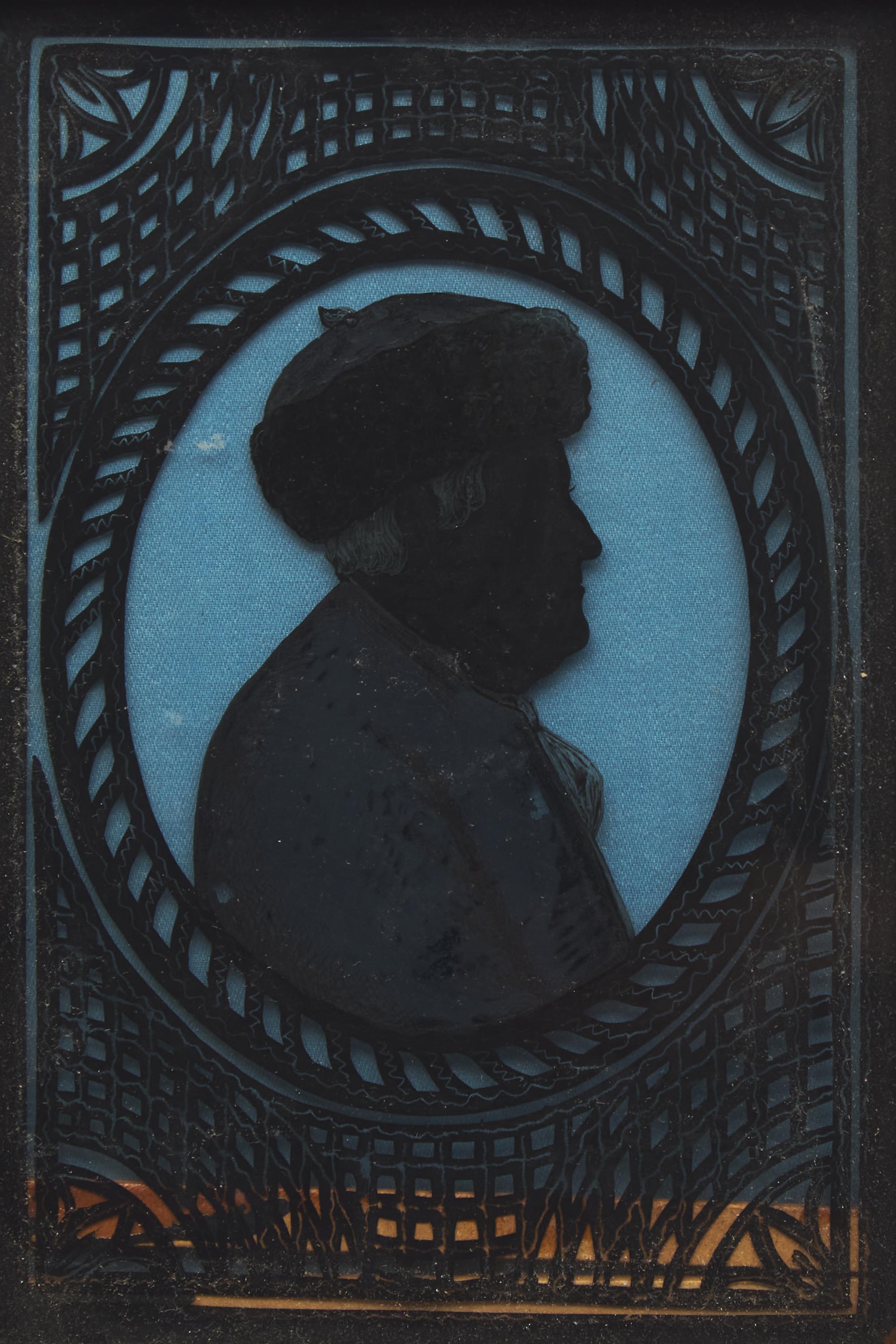 American School 19th Century, A Miniature Eglomise Silhouette Profile Portrait of Benjamin Franklin with Fur Cap