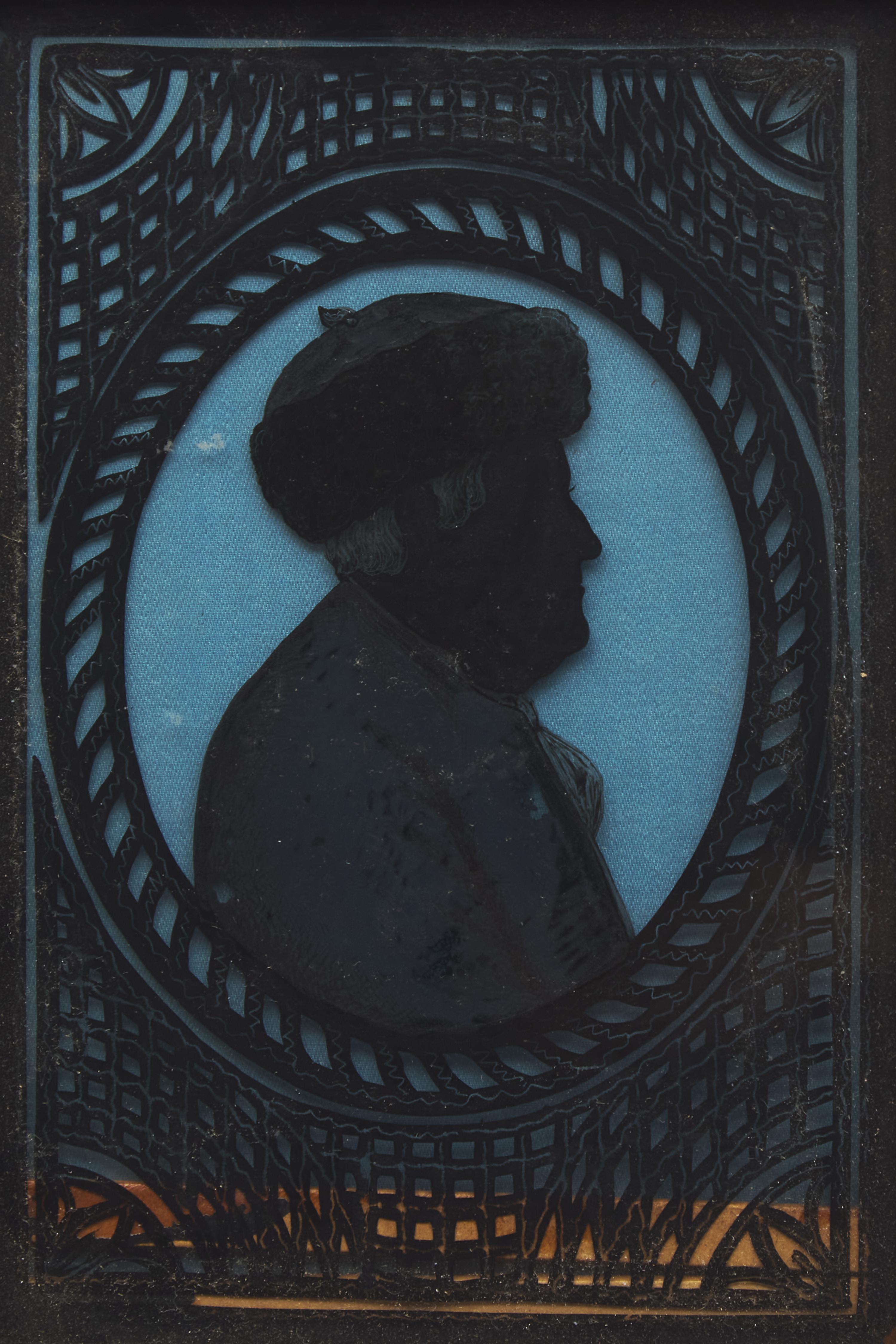 American School 19th Century, A Miniature Eglomise Silhouette Profile Portrait of Benjamin Franklin with Fur Cap