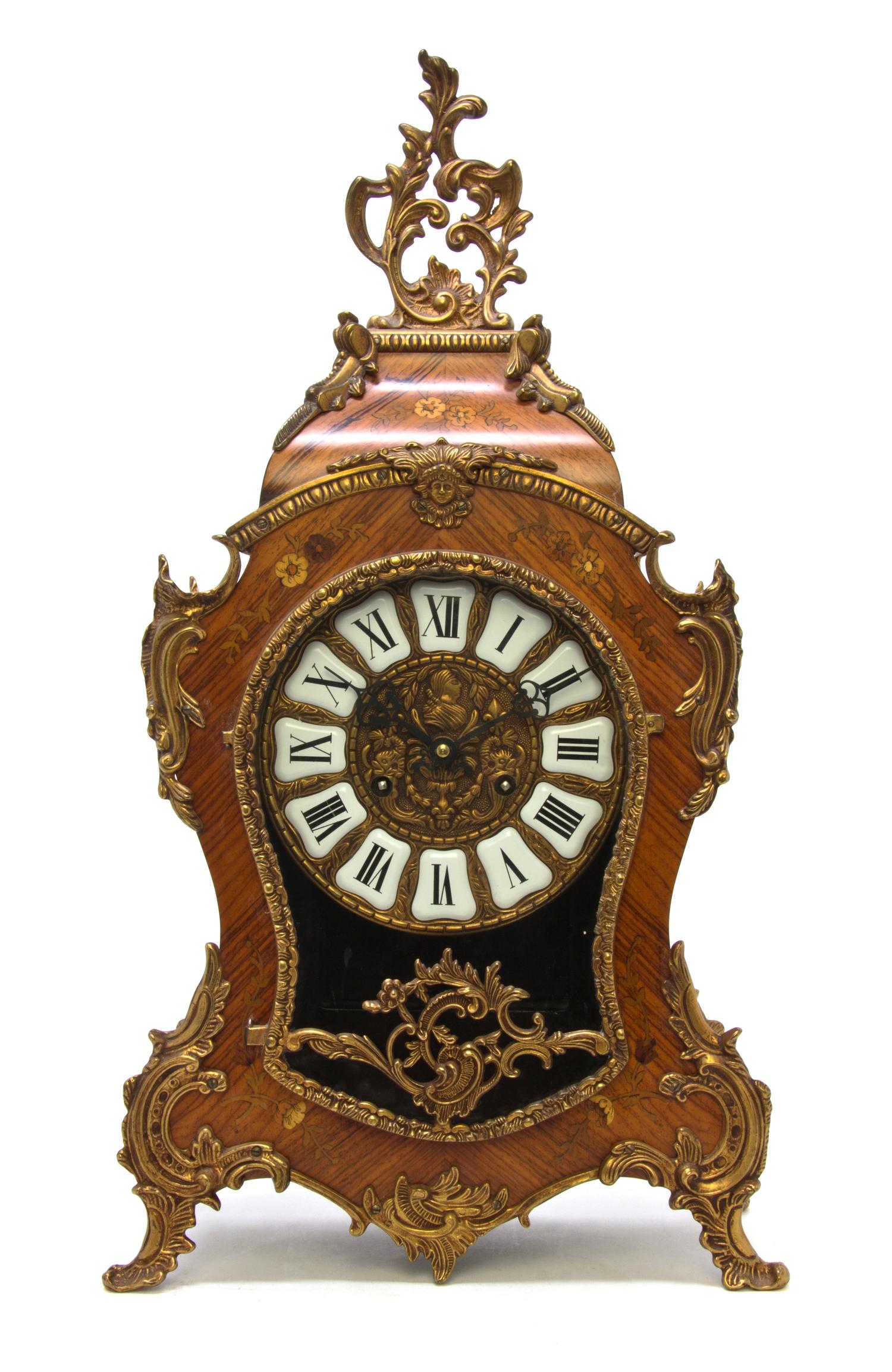 A Louis XV Style Marquetry and Gilt Metal Mounted Bracket Clock, Height 22 1/2 inches.