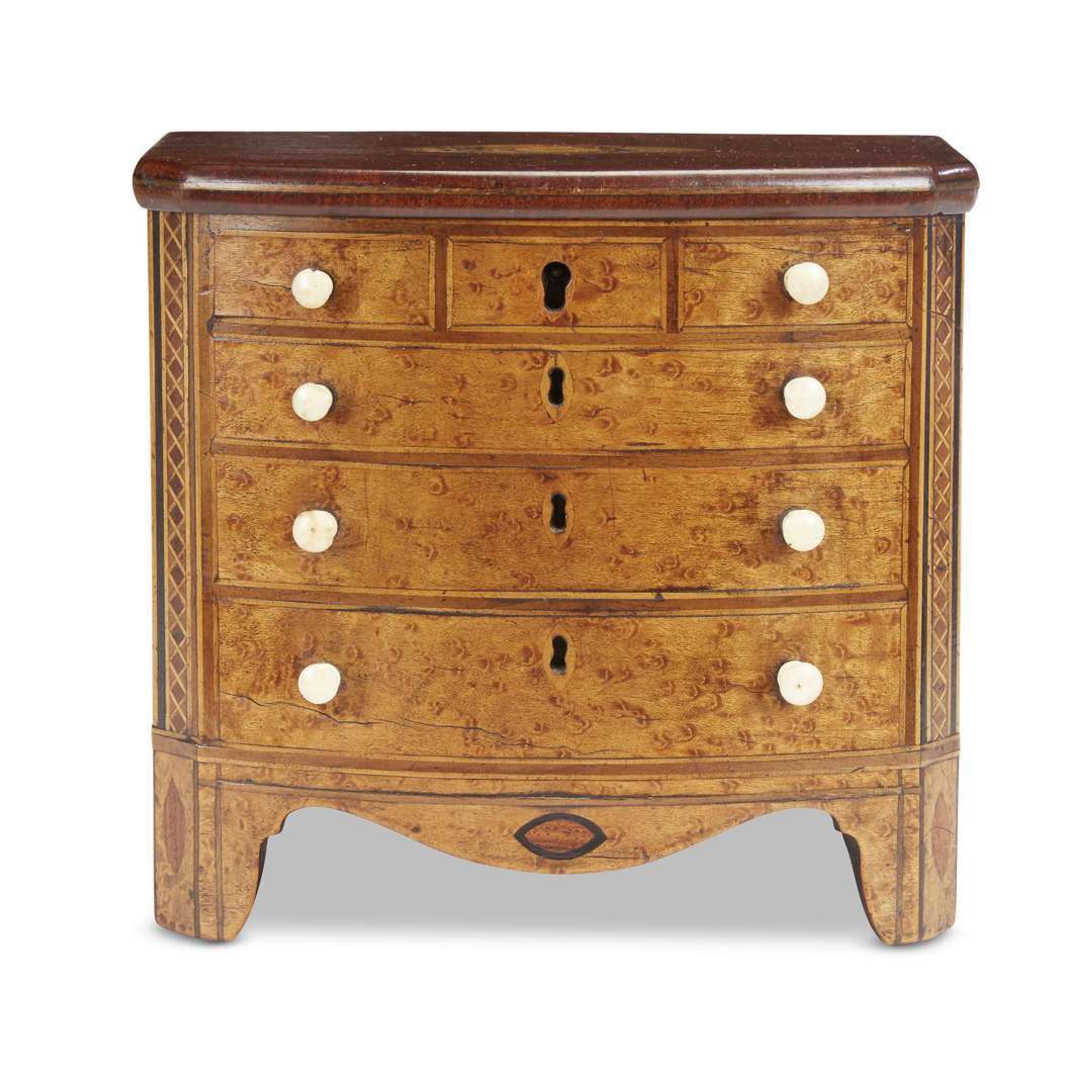 Inlaid bird's-eye maple tea caddy in the form of a miniature chest of drawers circa 1800