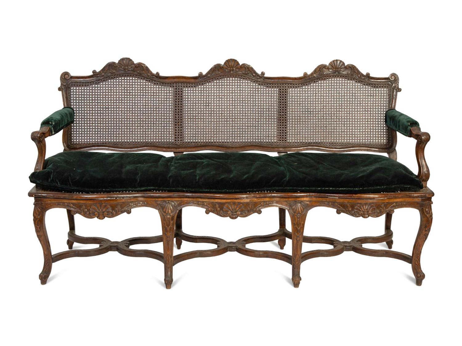 A Régence Style Carved Walnut Triple Chair-Back Settee