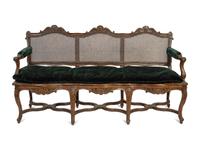 A Régence Style Carved Walnut Triple Chair-Back Settee