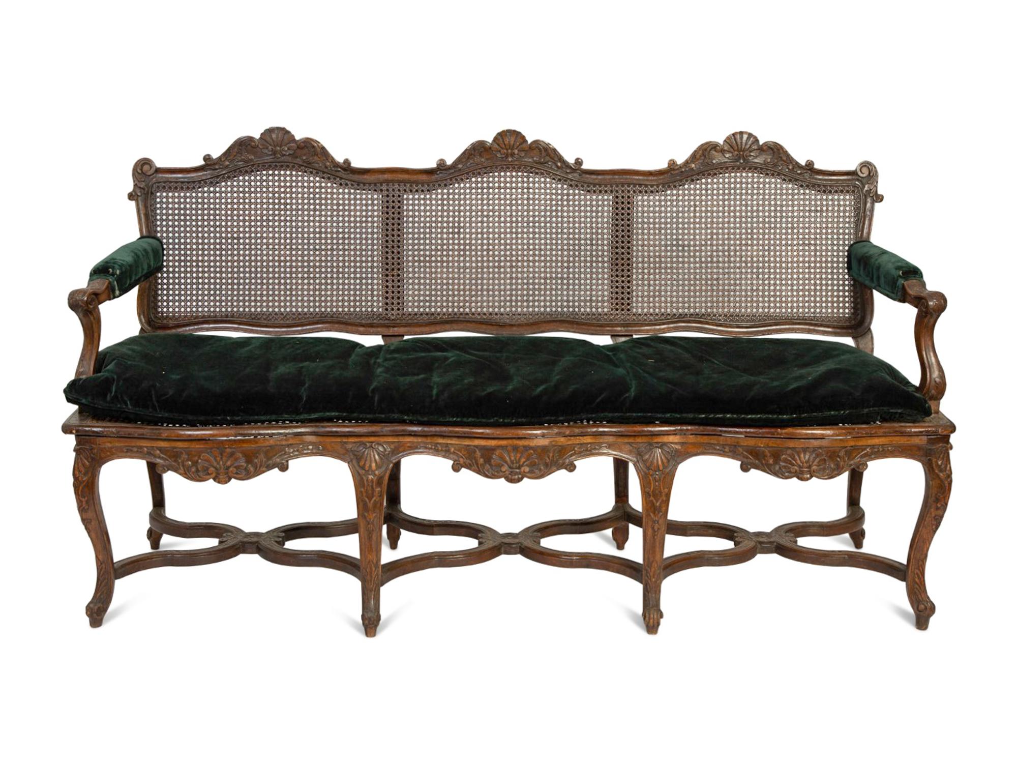 A Régence Style Carved Walnut Triple Chair-Back Settee