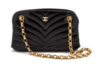 A Chanel Black Chevron Quilted Patent Leather Bag, 8 x 4 1/2 x 2 inches.