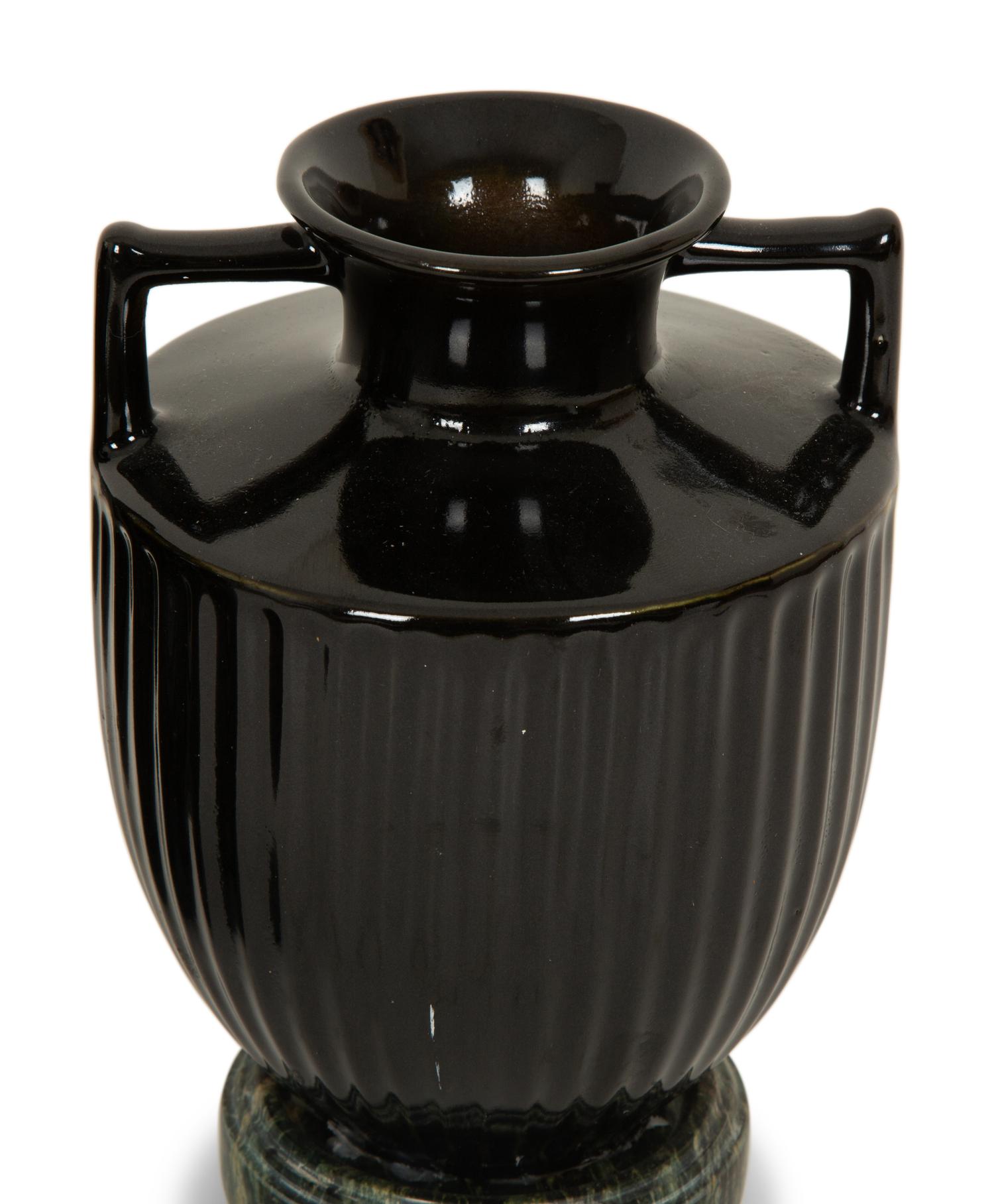 A Pair of Black Porcelain Urns on Green Marbelized Bases