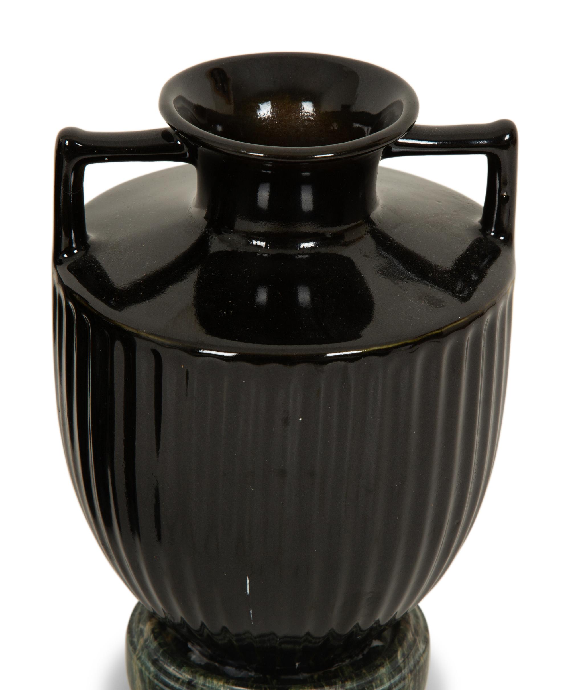 A Pair of Black Porcelain Urns on Green Marbelized Bases