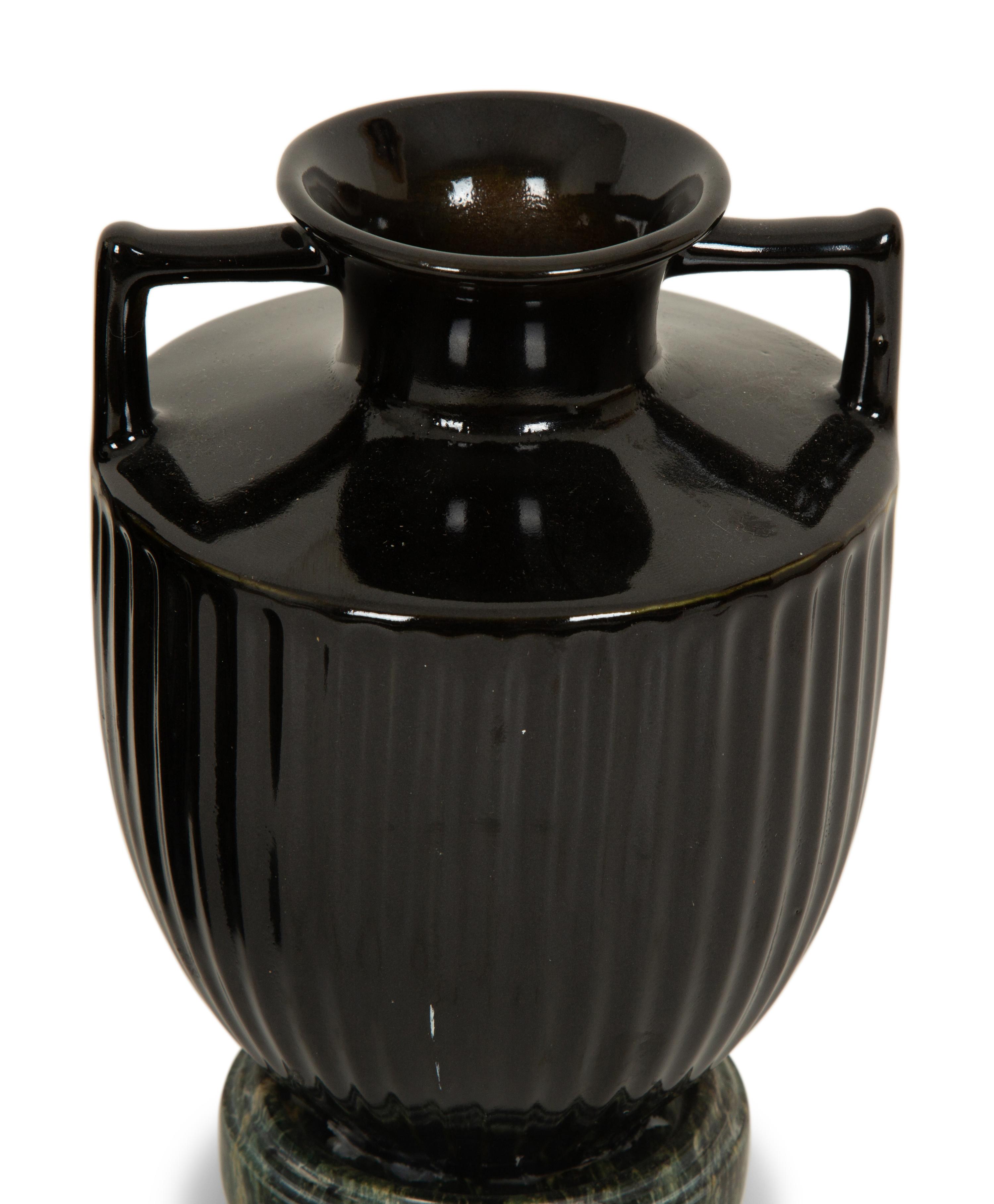 A Pair of Black Porcelain Urns on Green Marbelized Bases