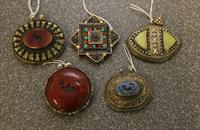 A Set of Five Asian Medallions. Width of widest 2 3/4 inches.