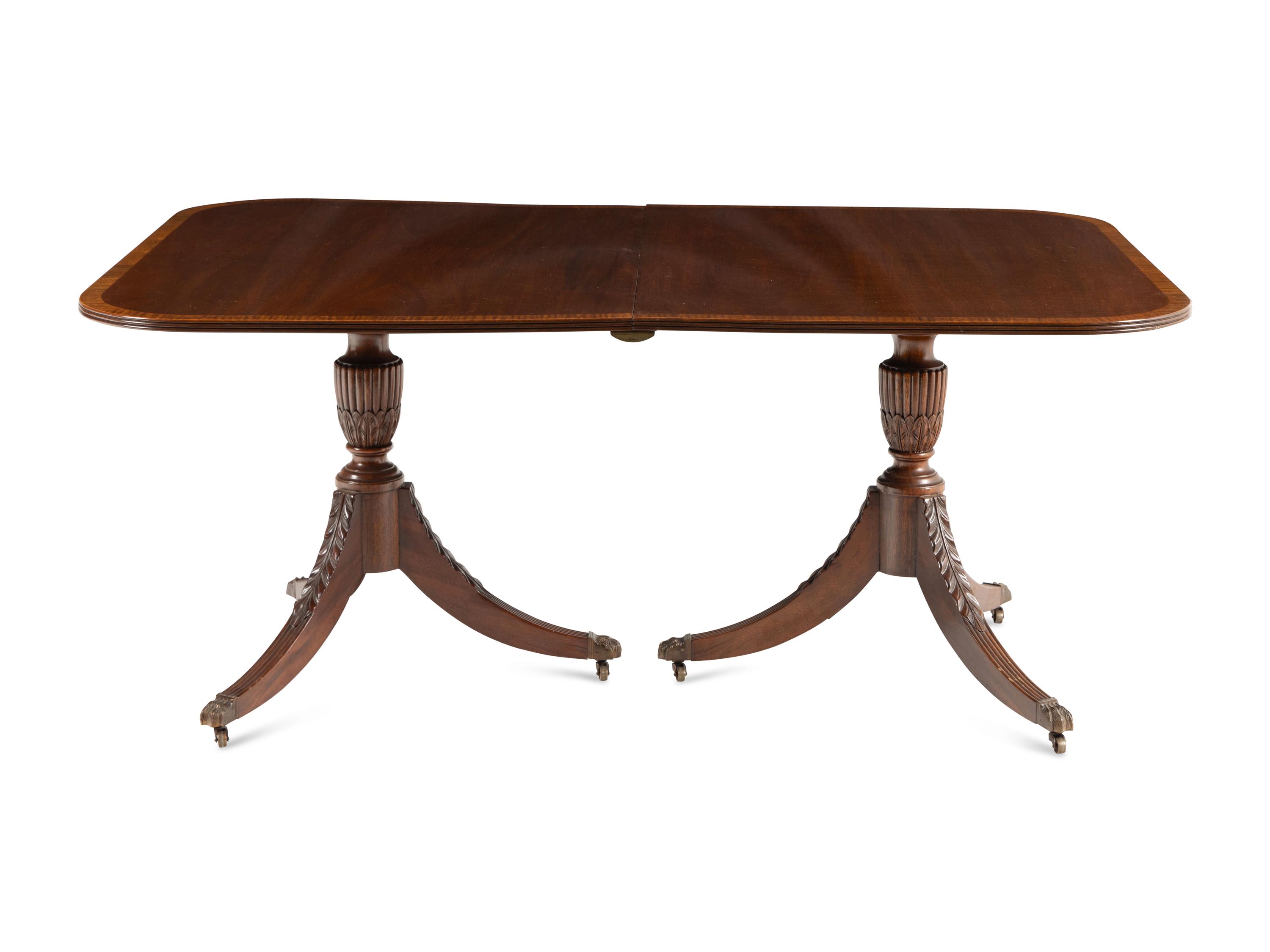 A Regency Style Mahogany and Satinwood Extension Dining Table