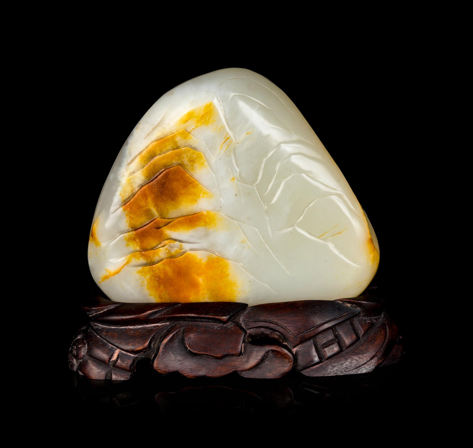 A Chinese White and Russet Jade Boulder