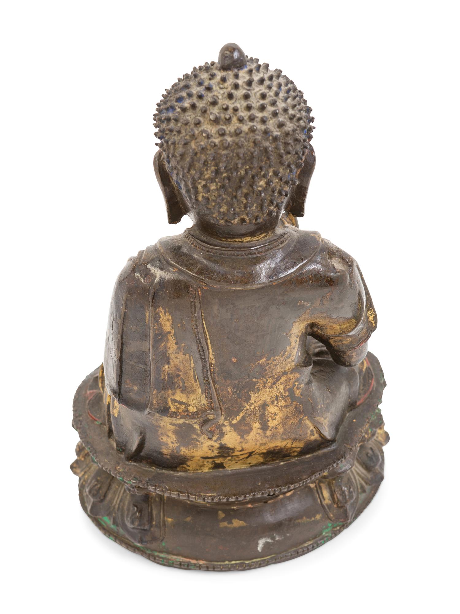 A Chinese Parcel-Gilt and Painted Bronze Figure of Seated Buddha Shakyamuni