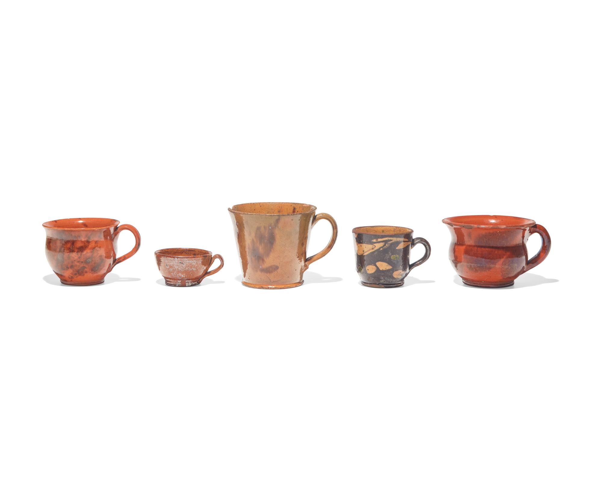 A Group of Five Glazed Redware Mugs and Porringers, Pennsylvania, 19th Century