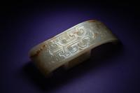 A Chinese White and Russet Jade Sword Slide, Jianzhi