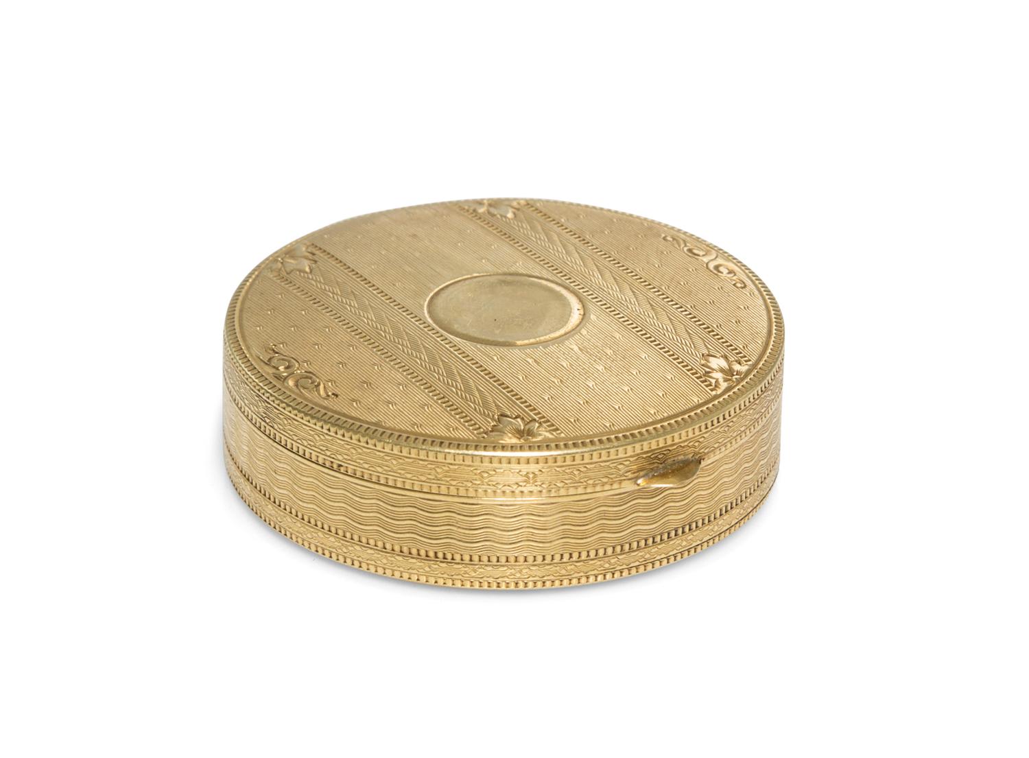 A 14 Karat Yellow Gold Pill Box, 20th Century, of circular form with an engine turned edge.