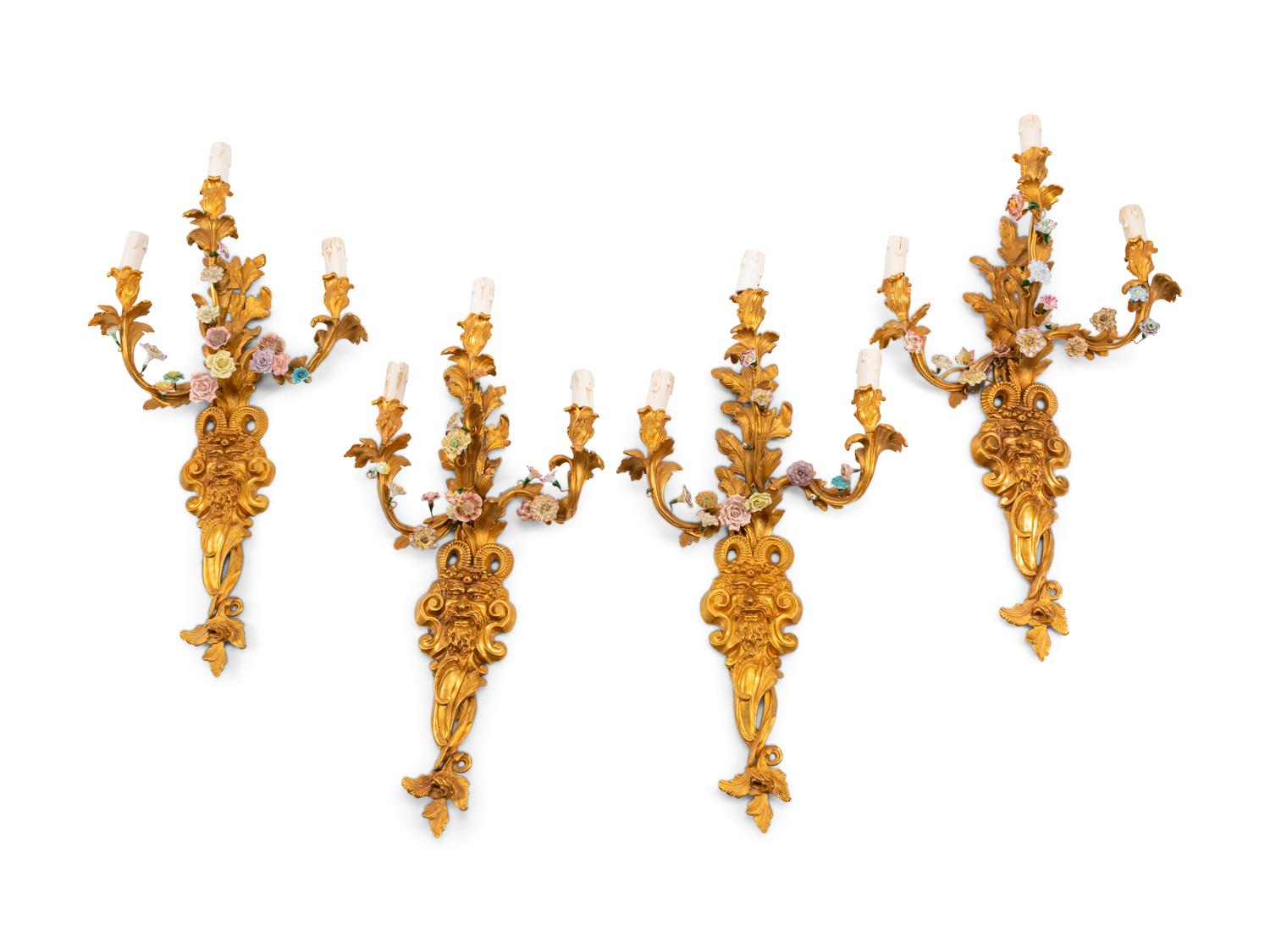 A Set of Four French Gilt Bronze and Porcelain Three-Light Sconces