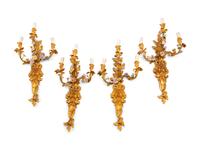 A Set of Four French Gilt Bronze and Porcelain Three-Light Sconces