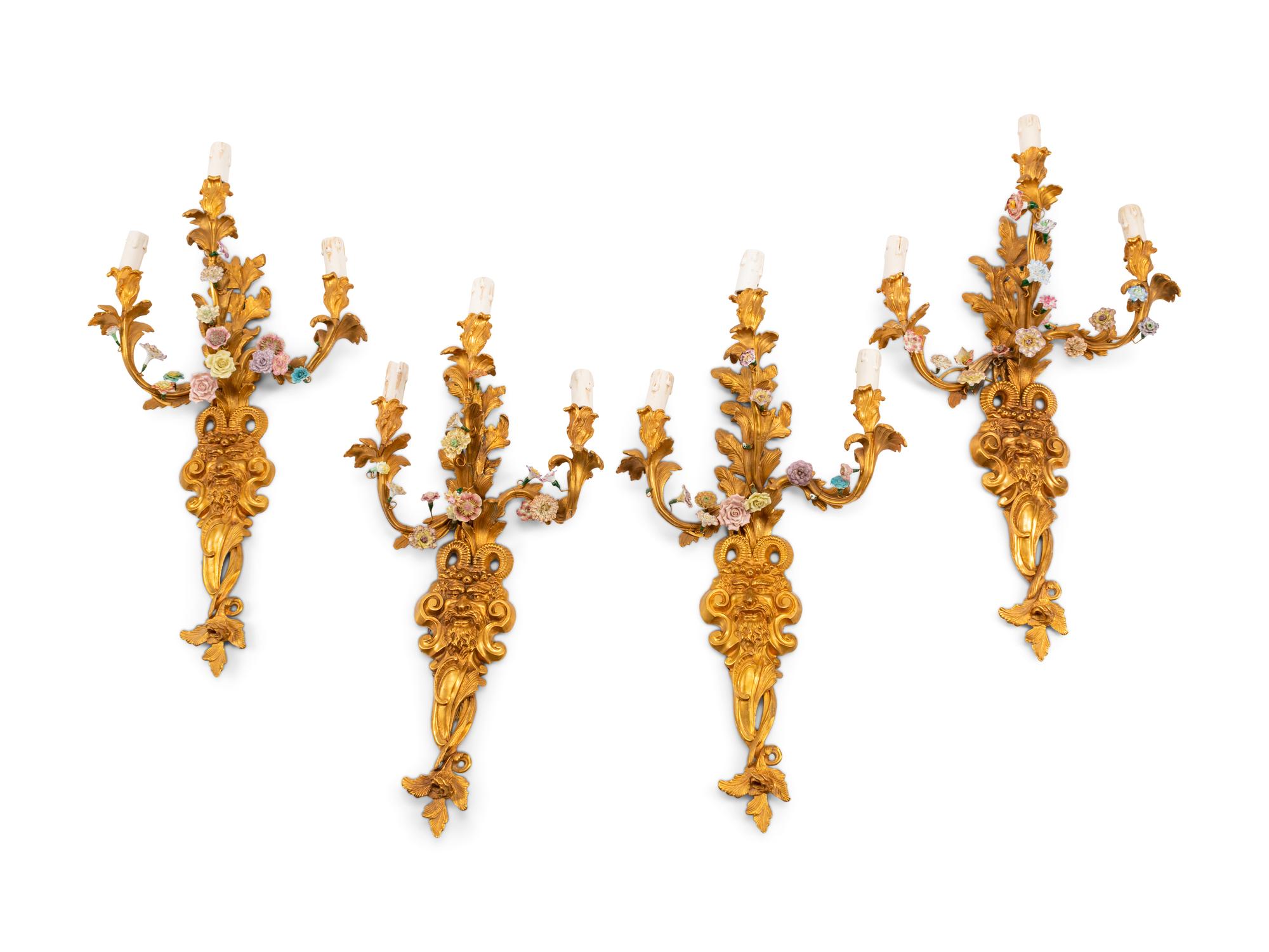 A Set of Four French Gilt Bronze and Porcelain Three-Light Sconces