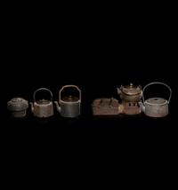 Seven Japanese Cast Iron Teapots, Tetsubin, and Burner