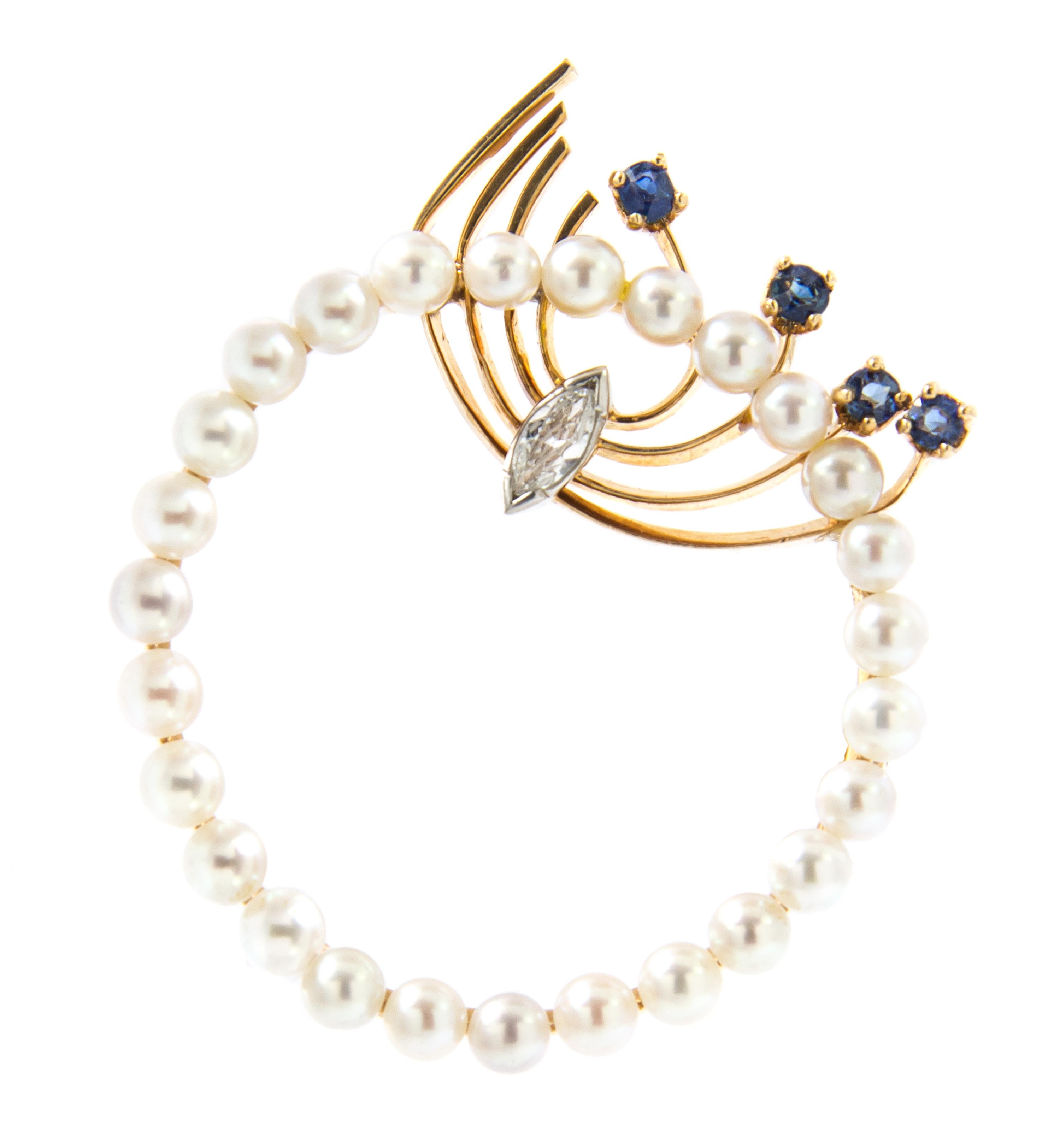 A 14 Karat Yellow Gold, Platinum, Cultured Pearl, Diamond and Sapphire Circle Brooch, 6.60 dwts.