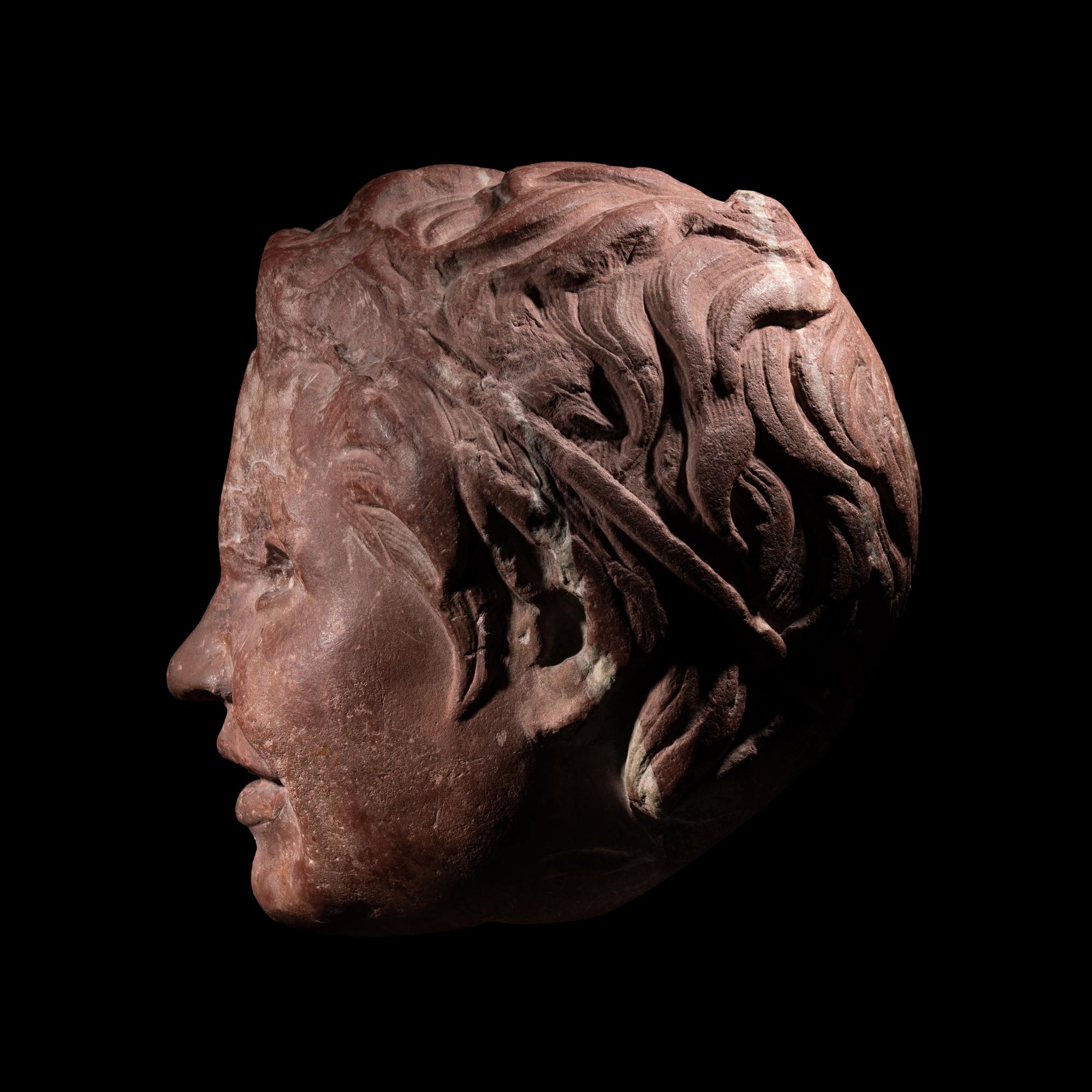 A Roman Rosso Antico Head of a Young Satyr