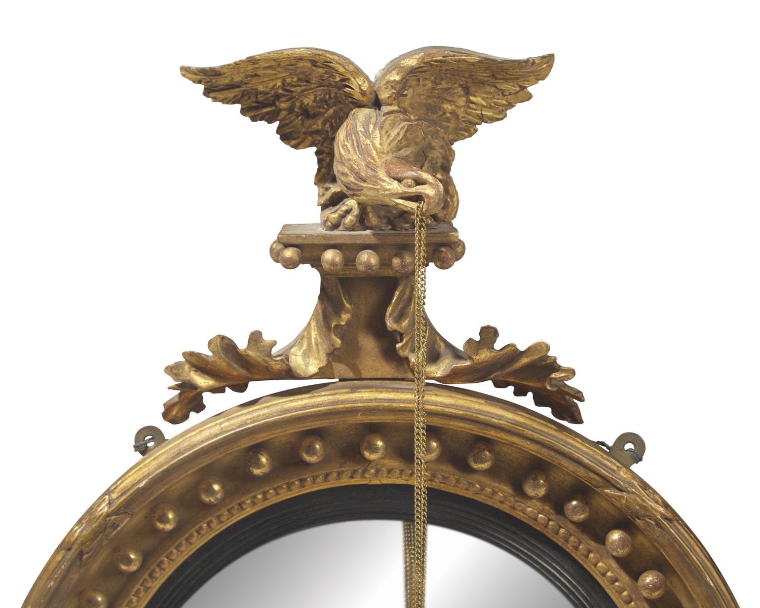 A Classical carved giltwood girandole bull's eye mirror, 19th century