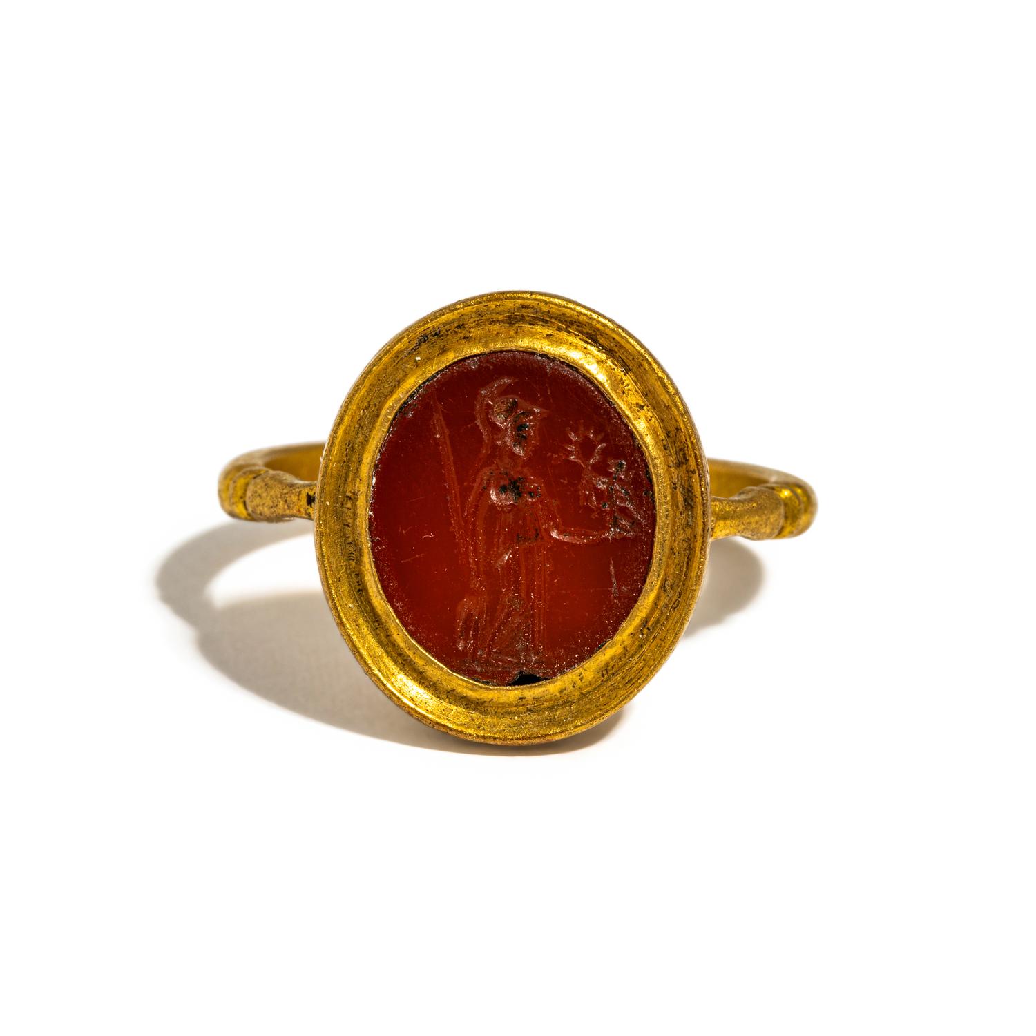 A Roman Gold and Carnelian Finger Ring with the Goddess Minerva Holding Nike