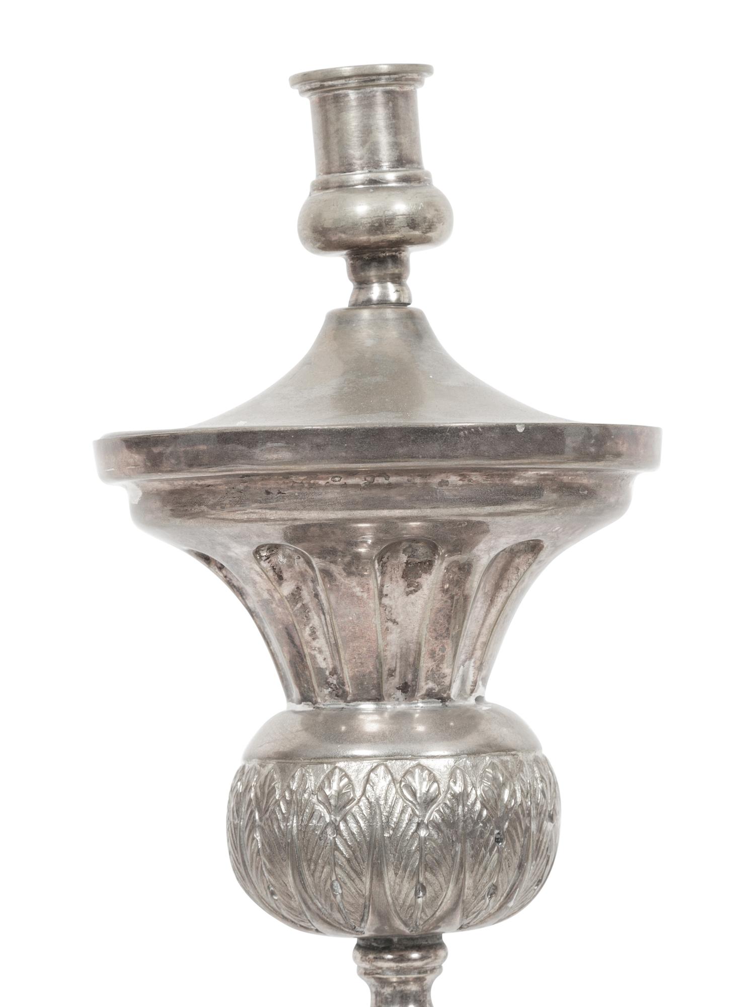 A Set of Four Continental Silvered Metal Candlesticks