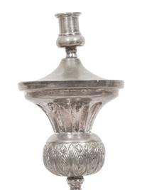 A Set of Four Continental Silvered Metal Candlesticks