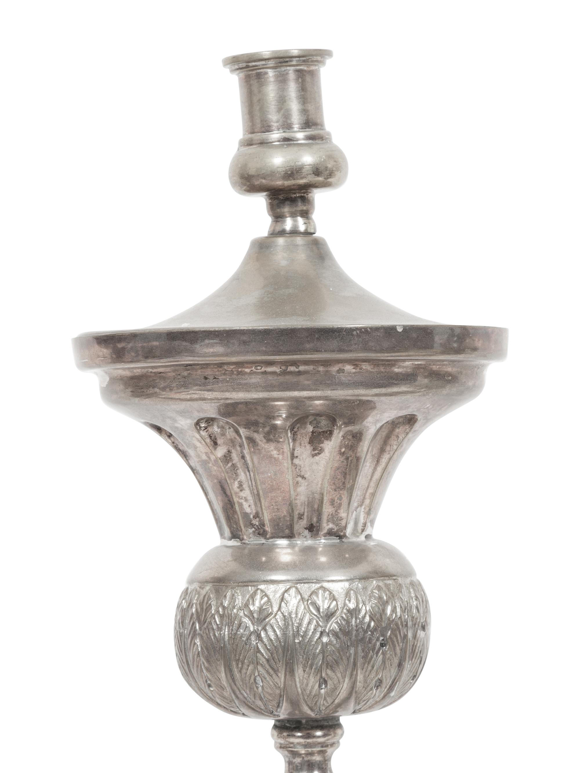 A Set of Four Continental Silvered Metal Candlesticks