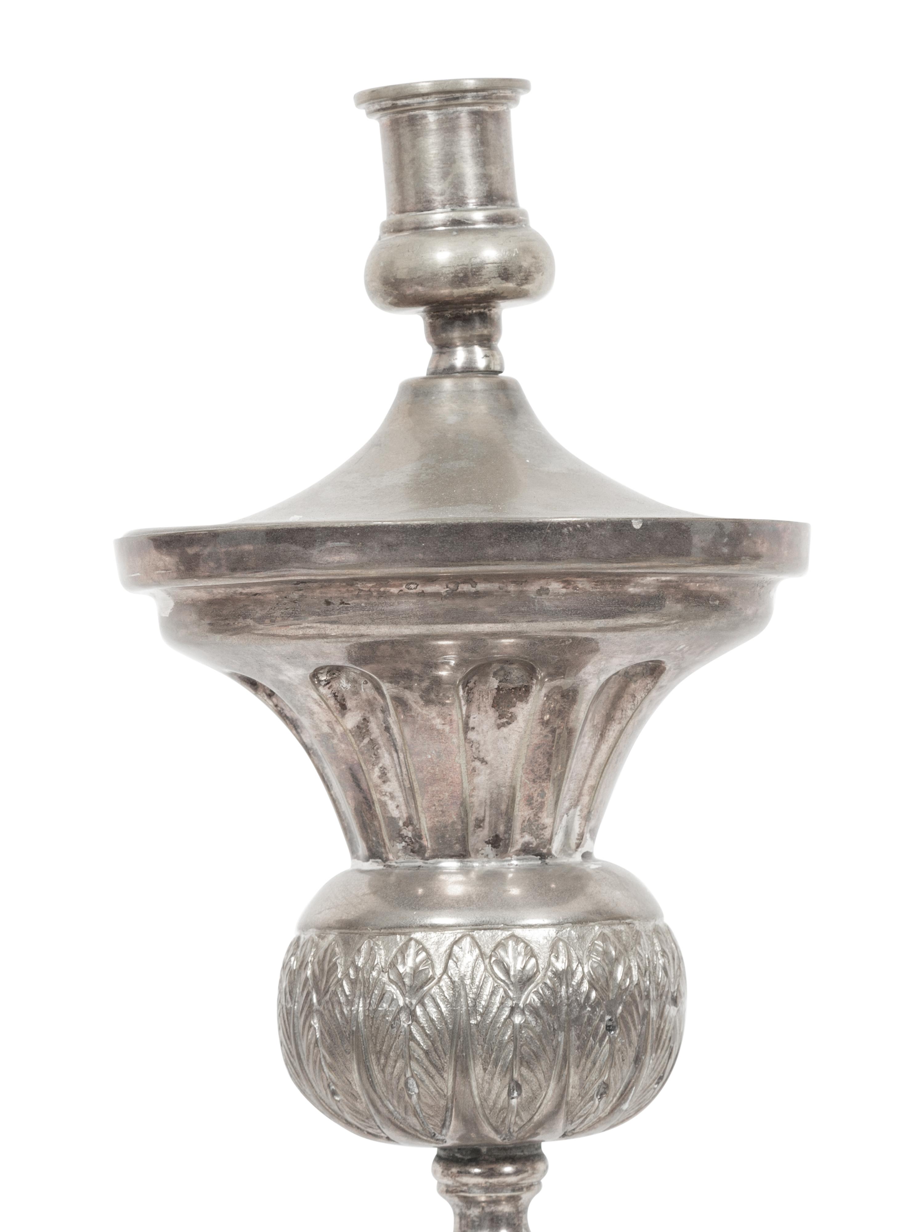 A Set of Four Continental Silvered Metal Candlesticks