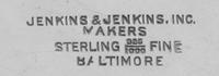 An American Silver Bread Basket, Jenkins & Jenkins Inc., Baltimore, MD, the volute and foliate decorated swivel handle surmounting a re