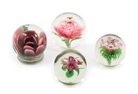 Four Floral Glass Paperweights Diameter of largest 3 1/4 inches