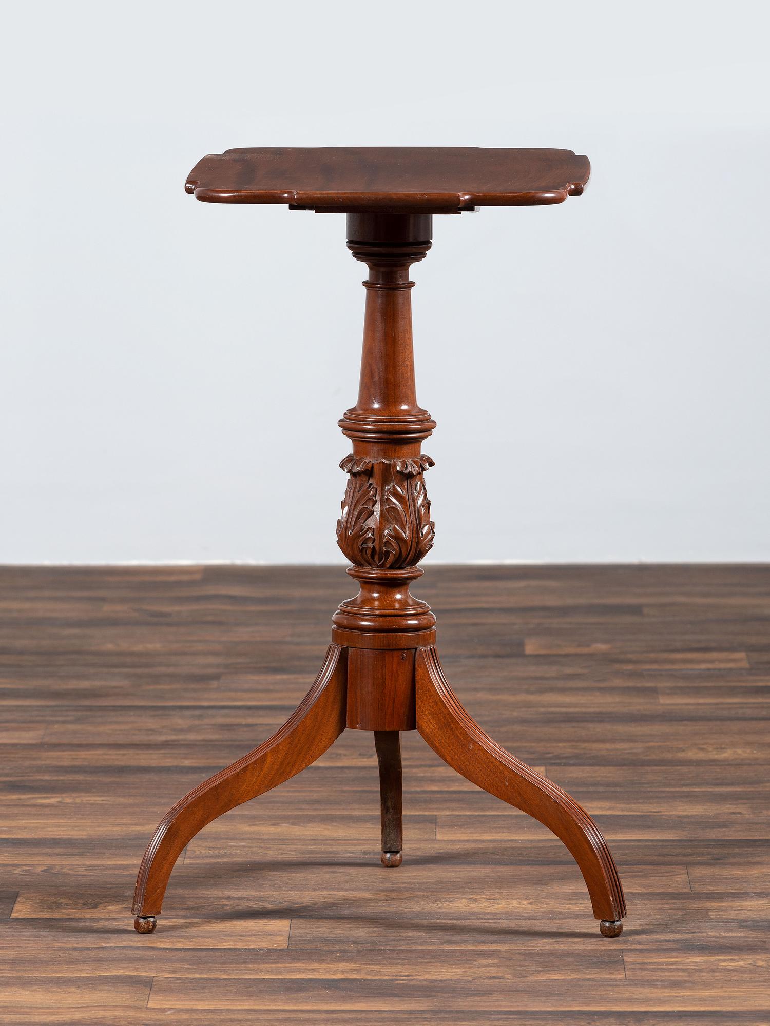A Late Federal Carved and Figured Mahogany Shaped Top Candlestand