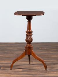A Late Federal Carved and Figured Mahogany Shaped Top Candlestand