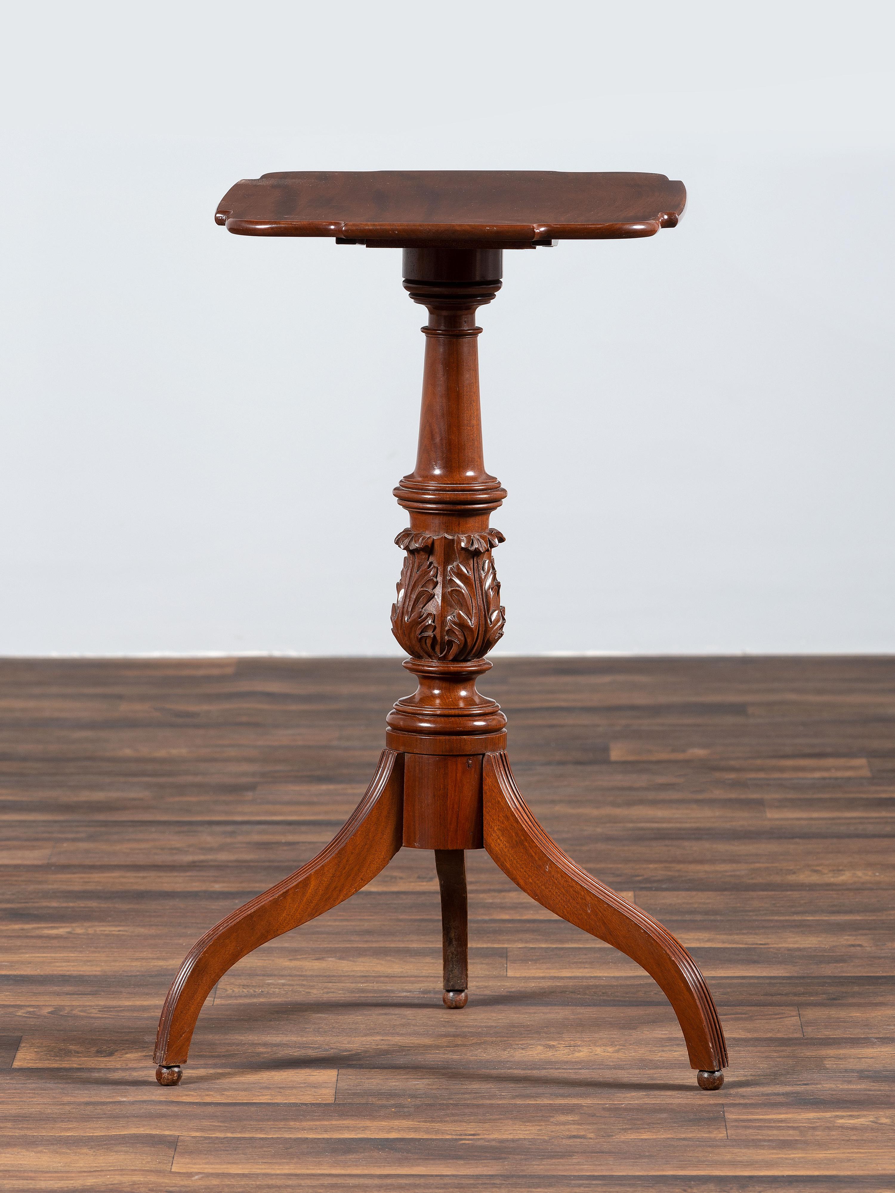 A Late Federal Carved and Figured Mahogany Shaped Top Candlestand