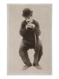 CHAPLIN, Charles (1889-1977). RPPC and portrait featuring Charlie Chaplin as "The Tramp."