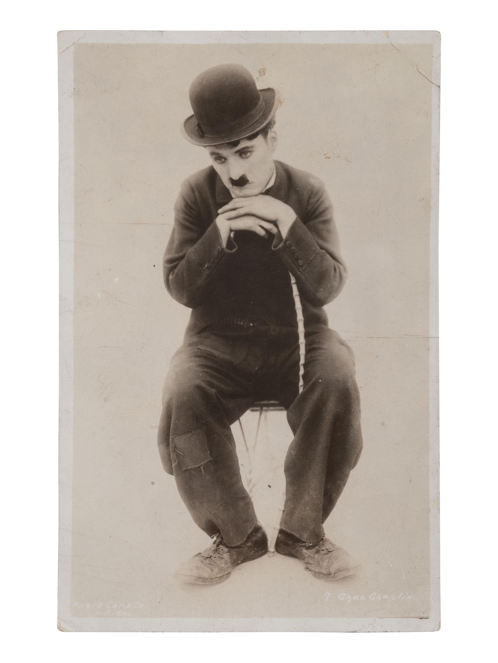 CHAPLIN, Charles (1889-1977). RPPC and portrait featuring Charlie Chaplin as "The Tramp."