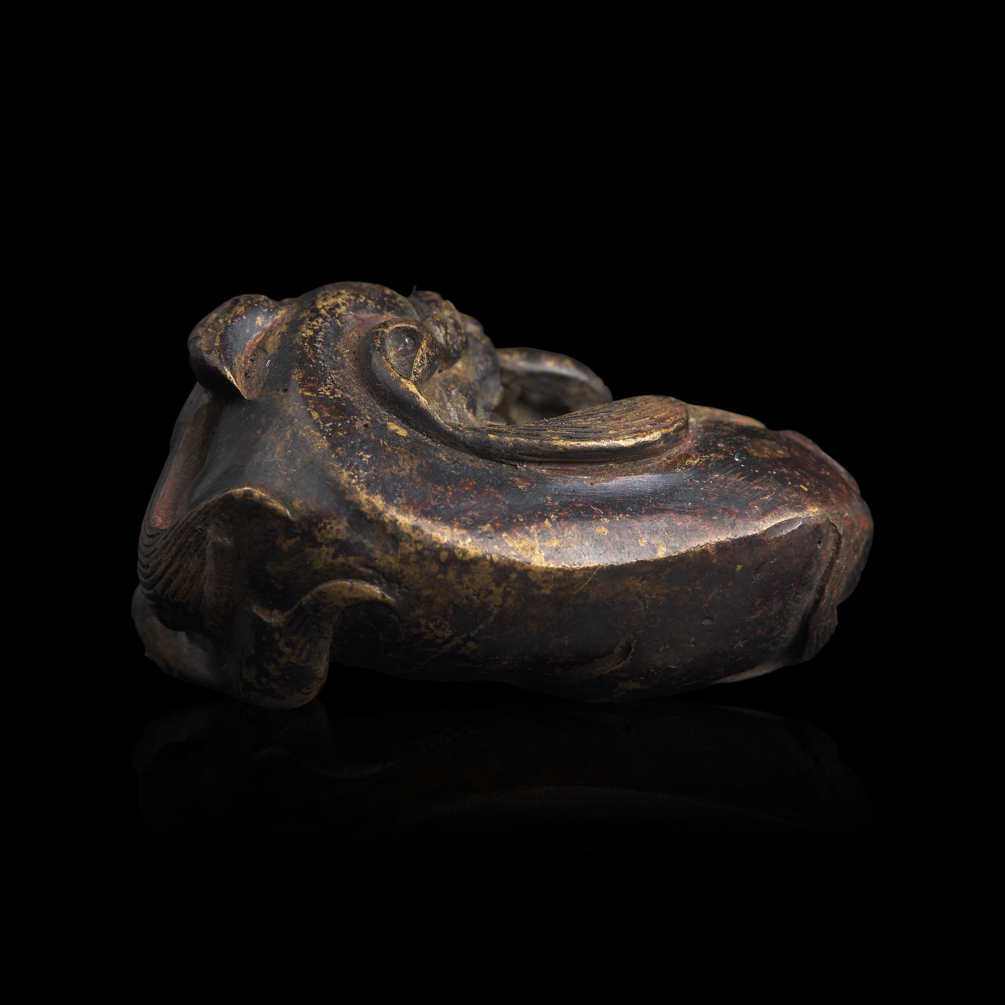 A Chinese Patinated Bronze Figure of a Stylized Lion, Late Ming-Early Qing Dynasty — 明末清初 銅獅鎮紙